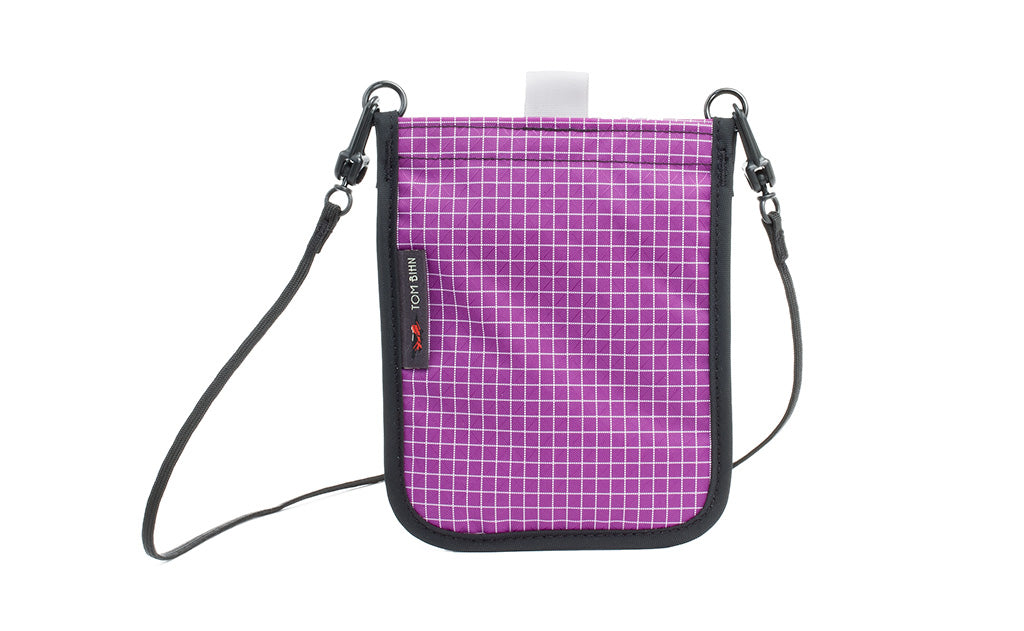 visible variant TB0932-UD TB0931-UD^^The Passport Pouch in Ultraviolet (purple with white grid) 200 Halcyon.