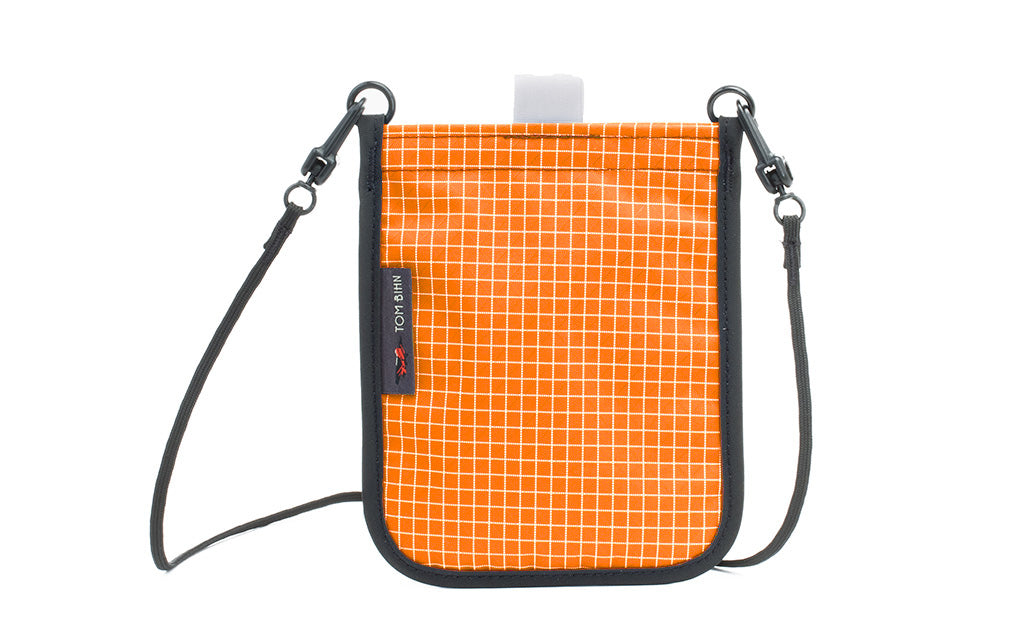 visible variant TB0931-ZD TB0932-ZD^^The Passport Pouch in Zest (orange with white grid) 200 Halcyon.