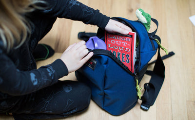 detail visible^^A child taking a book out of The Sprout.