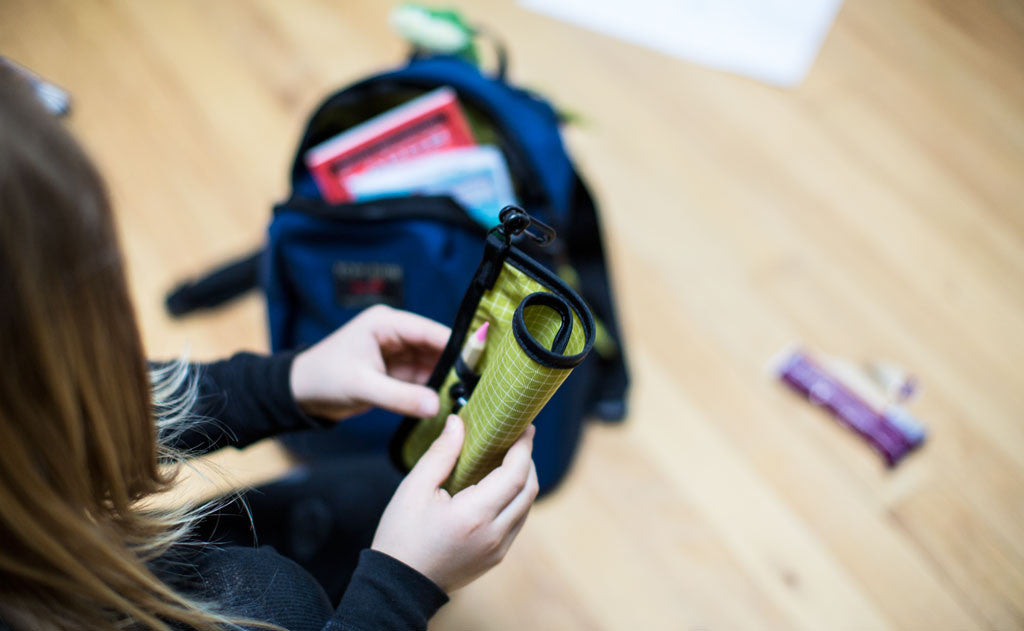 ^^A child opening a Pen Tool Kid beside The Sprout.