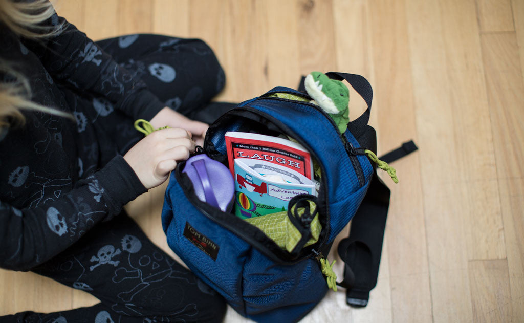 detail visible^^A child zipping up the zipper of The Sprout.