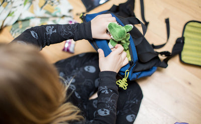 detail visible^^A child pulling a stuffed animal from the top pocket of The Sprout.