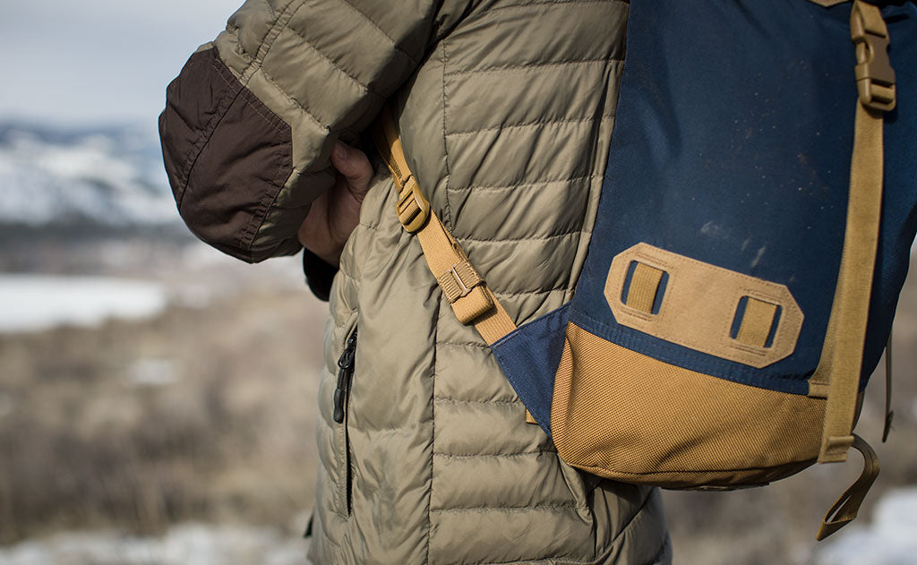 ^^A Coyote (brown) Strap Keeper holding a shoulder strap's rolled excess length out in place.