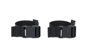 visible^^A pair of stroller/wheelchair adapter straps.