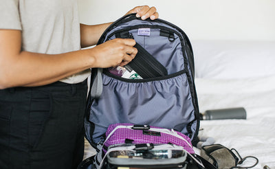 visible lifestyle^^person clipping a pouch to an internal o-ring
