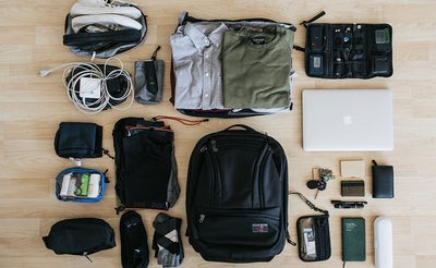 lifestyle visible^^A packing shot of the Synik 30 with clothing, photography equipment, chargers, a travel shaver, and various othe accessories.