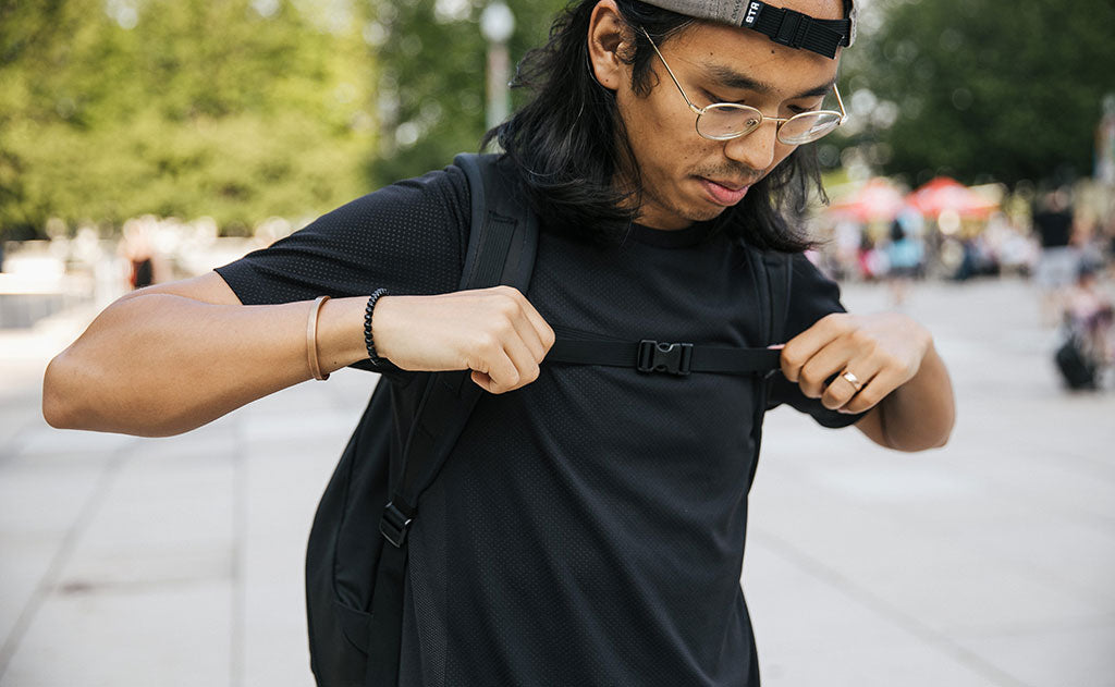 A person adjusting the sternum strap on the Synik 30.