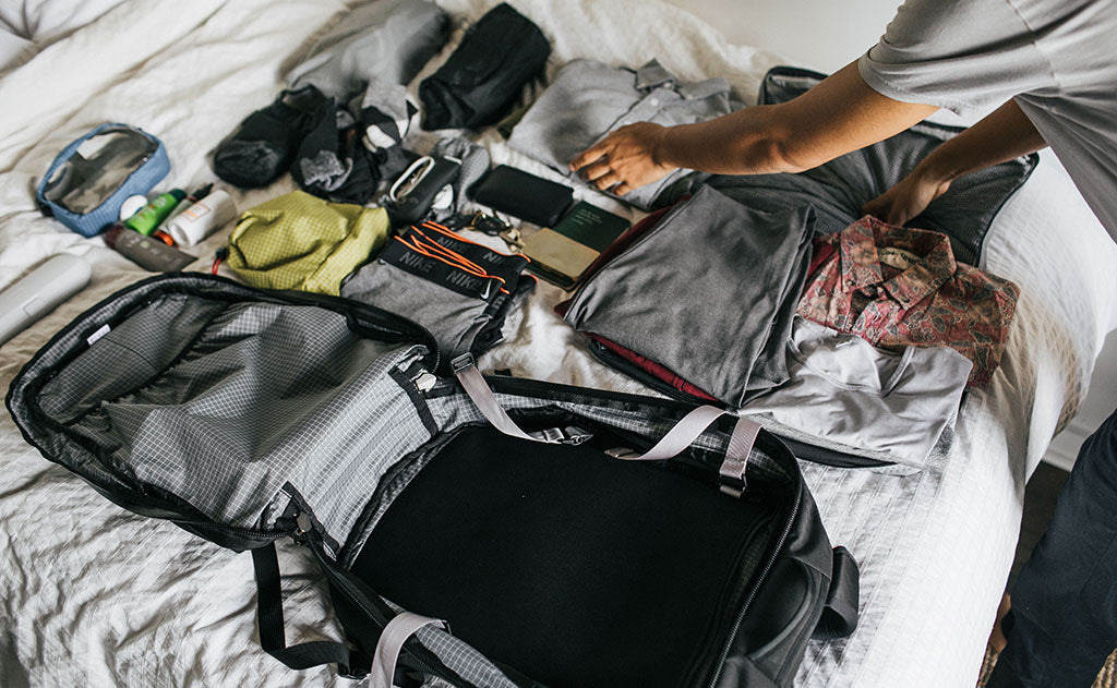 A person packing clothing into the Synik 30.