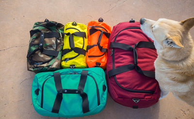lifestyle  visible^^Left to right: Small Yeoman in Beaver Camo, Mini Yeoman in Canary, Mini Yeoman in Orange 152, Large Yeoman in Red Blend, Ichiro the dog, Medium Yeoman in Mayura