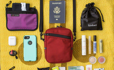 lifestyle visible^^Photo with items around an Everyday Cubelet that might fit inside: passport, phone, make-up, earbuds, headlamp, eye mask.