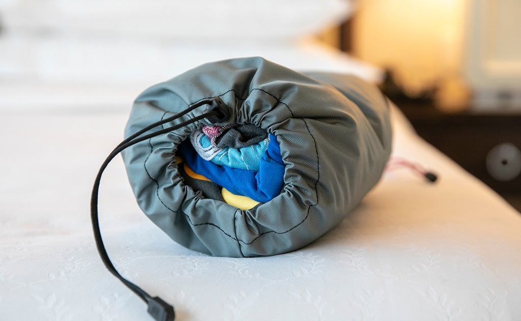 lifestyle visible^^A Travel Laundry Stuff Sack cinched closed.