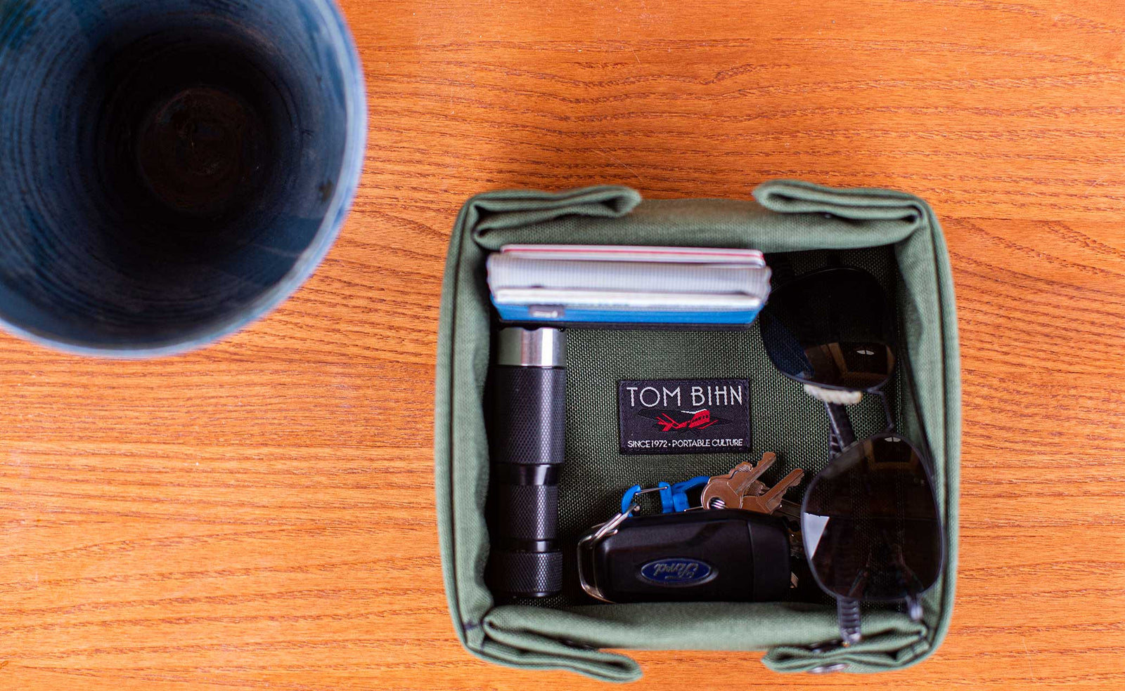 detail visible^^Small Tray Bien in Boreal holding a Nik's Minimalist Wallet, EDC flashlight, sunglasses, and car keys.