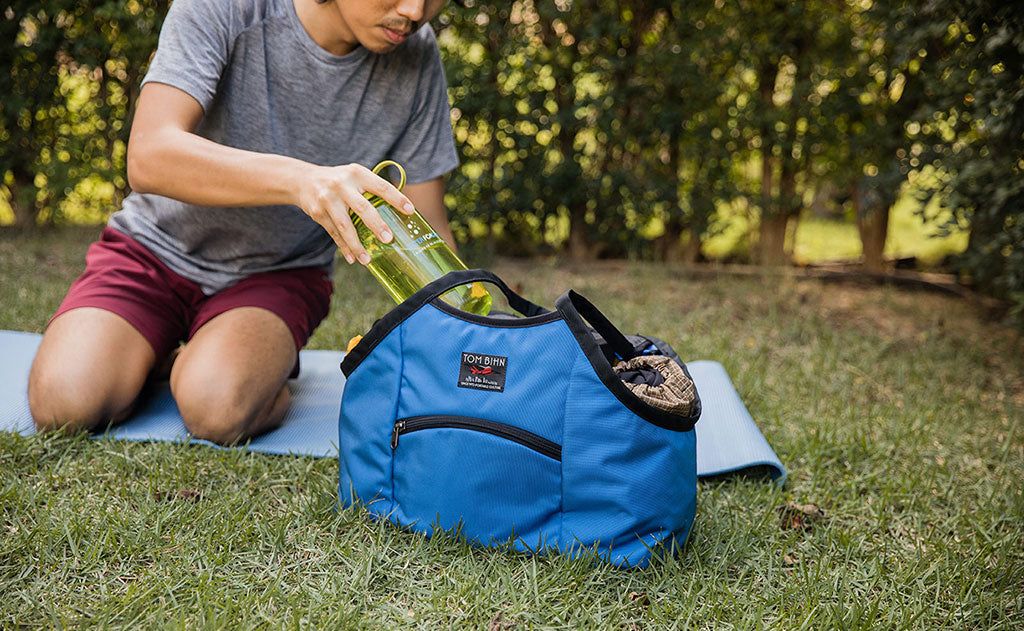 lifestyle visible^^Person on a yoga mat pulling a water bottle out of the Truckasana.
