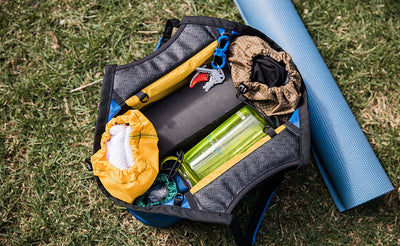 lifestyle visible^^The Truckasana tote bag opened to show Stuff Sacks in both end compartments and a yoga block and water bottle in the middle. 