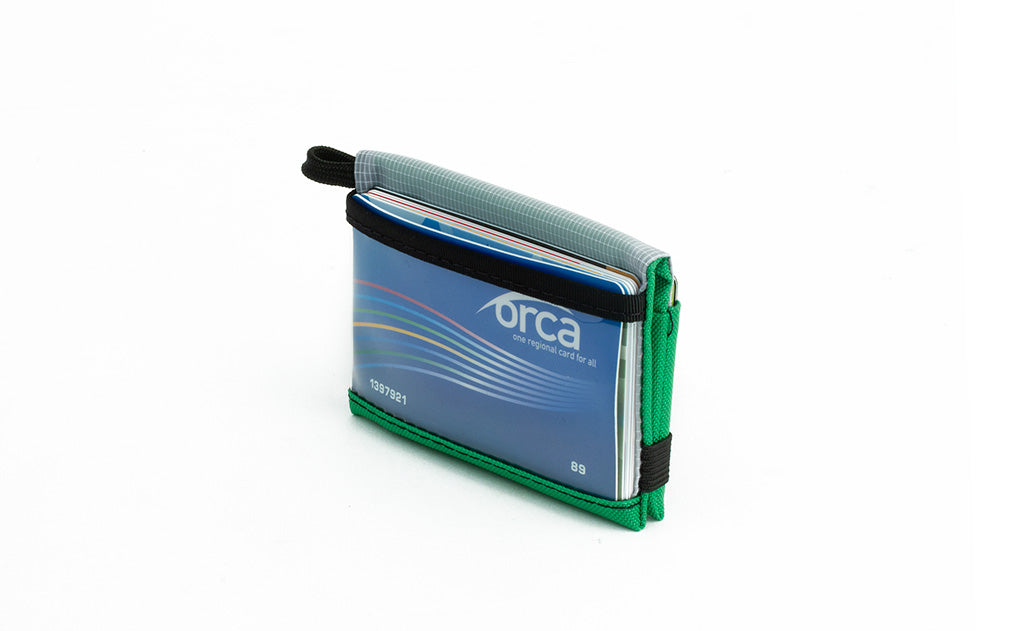 visible variant TB1280-GJ^^The Size 4 Nik's Minimalist Wallet in Grass (bright green) 210 Ballistic closed interior pockets-out with the attached elastic band.