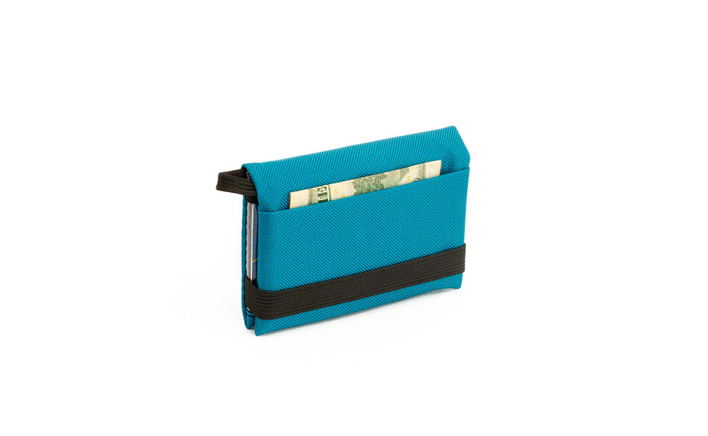 visible variant TB1280-VJ^^The Size 4 Nik's Minimalist Wallet in Virdian (blue-green) 210 Ballistic closed with the attached elastic band.