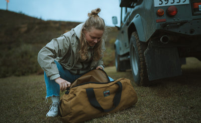lifestyle visible ^^ A person opening the Large Yeoman Duffel.