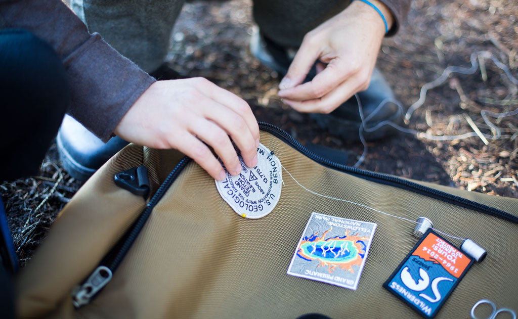 lifestyle  visible ^^ A person sewing a patch onto their Yeoman Duffel